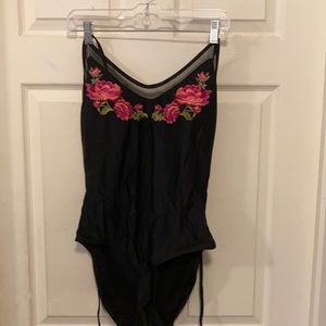 super cute black one piece with flowers on the chest area!